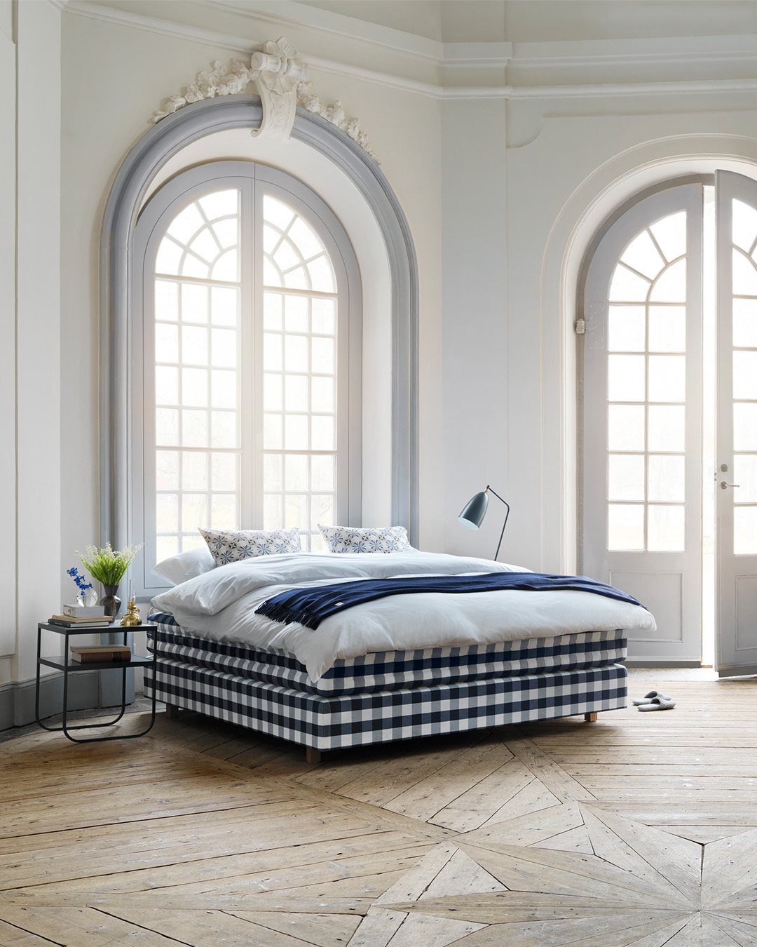 Hästens blue checked bed in a light bedroom