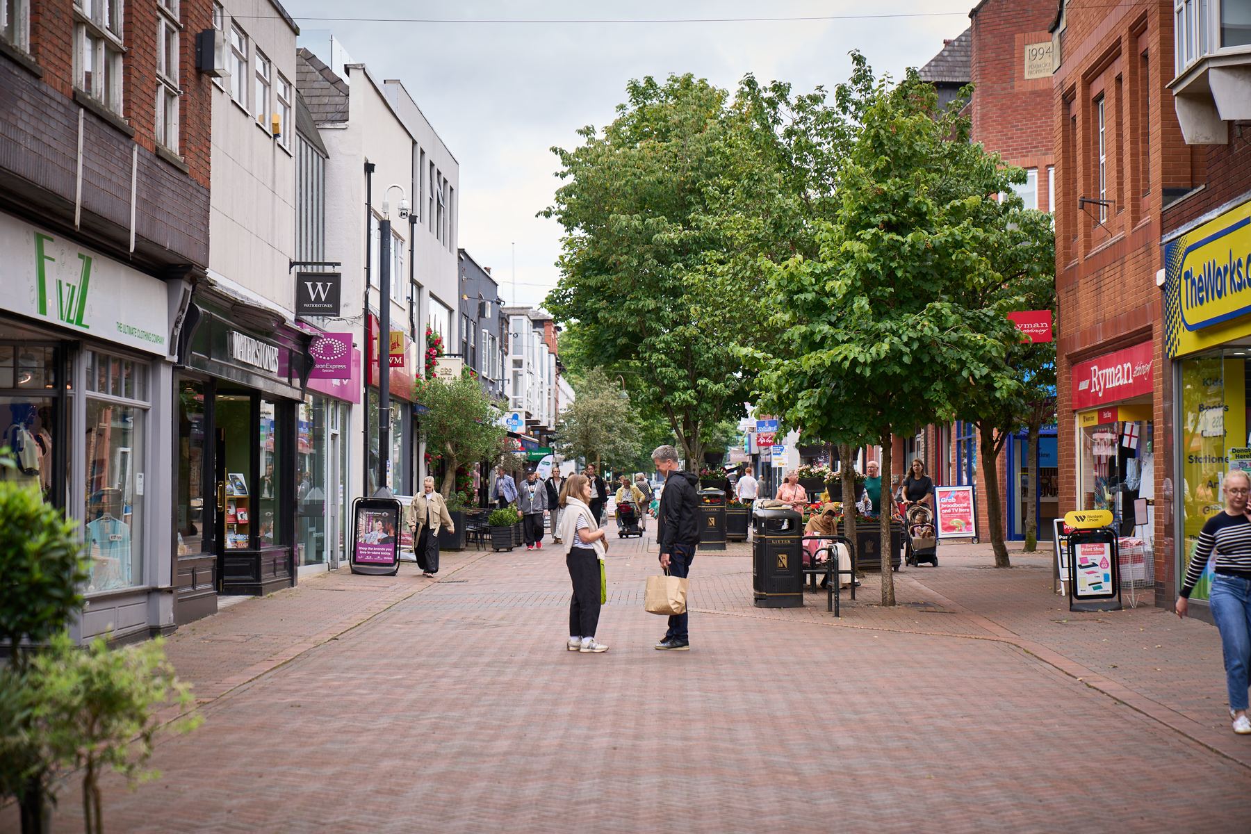 Pedestrians in Wilmslow town centre shopping area